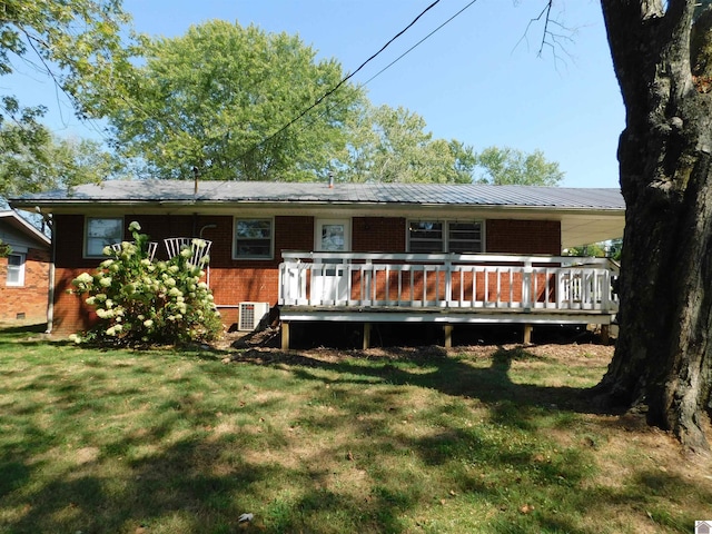 view of front of house with a deck and a front yard