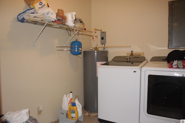 laundry area featuring electric panel, gas water heater, washer and clothes dryer, and light tile patterned floors