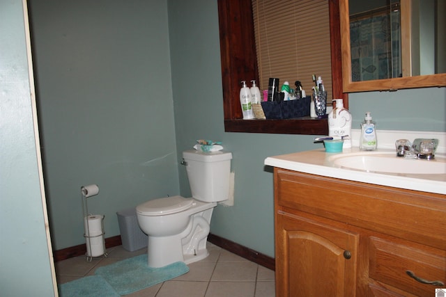 bathroom featuring tile patterned flooring, vanity, and toilet