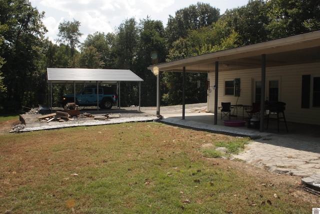 view of yard featuring a carport and a patio area