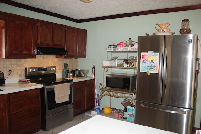 kitchen featuring a textured ceiling, light tile patterned floors, stainless steel appliances, ornamental molding, and decorative backsplash