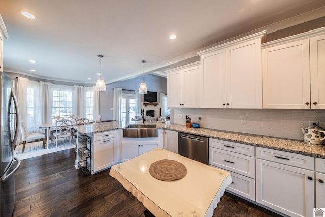 kitchen featuring ornamental molding, white cabinetry, decorative backsplash, dark wood-type flooring, and appliances with stainless steel finishes