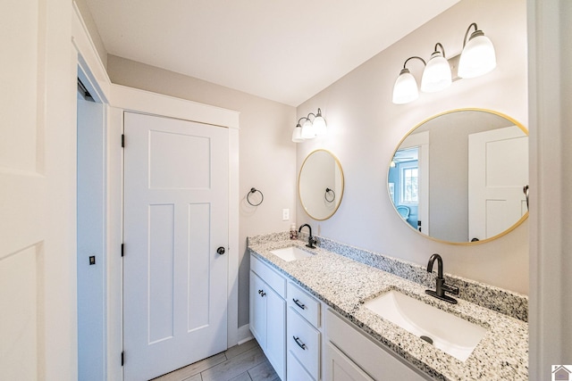 bathroom featuring tile patterned flooring and vanity