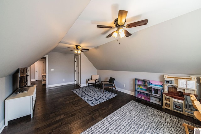 interior space featuring dark wood-type flooring, lofted ceiling, and ceiling fan