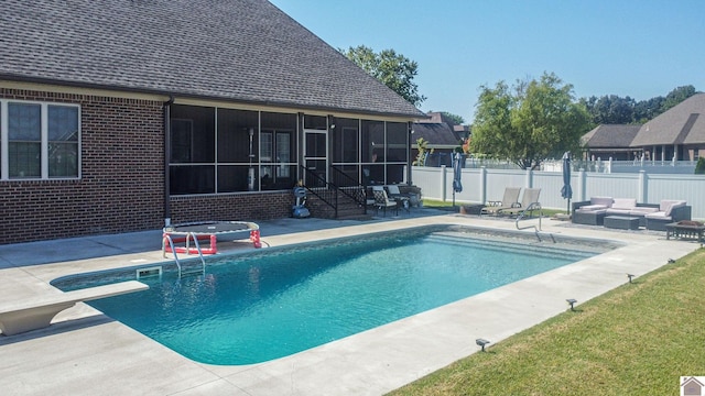 view of pool with a fenced in pool, outdoor lounge area, a sunroom, a patio area, and a fenced backyard