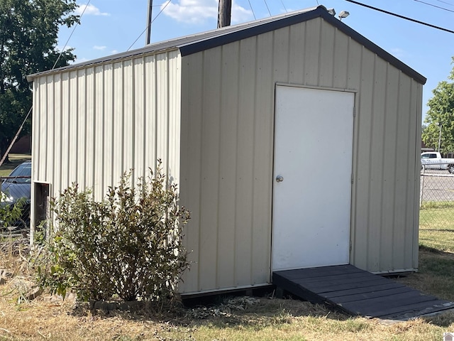 view of shed featuring fence