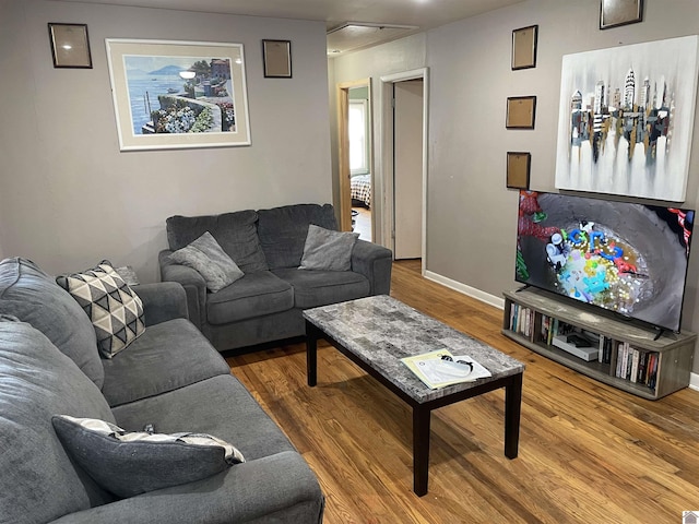 living area with wood finished floors and baseboards