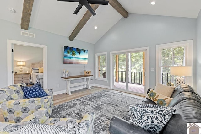 living room featuring high vaulted ceiling, ceiling fan, beamed ceiling, and light wood-type flooring