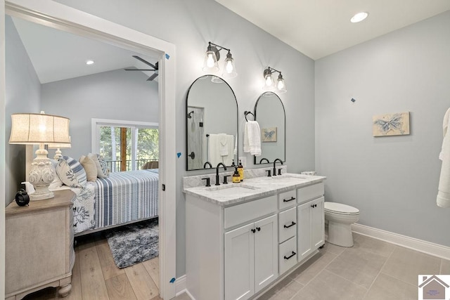 bathroom with toilet, vanity, ceiling fan, lofted ceiling, and hardwood / wood-style flooring