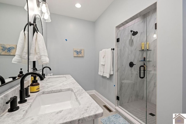 bathroom featuring vanity and an enclosed shower