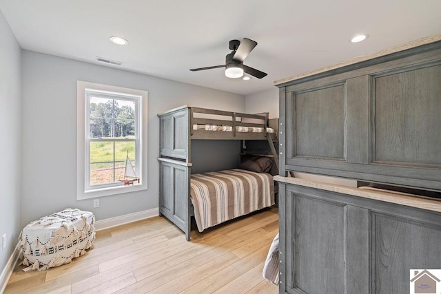 bedroom with ceiling fan and light hardwood / wood-style floors