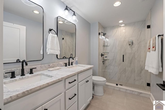 bathroom with vanity, toilet, a shower with shower door, and tile patterned floors