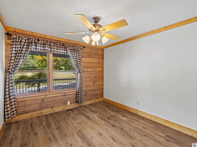 spare room with ceiling fan and hardwood / wood-style flooring