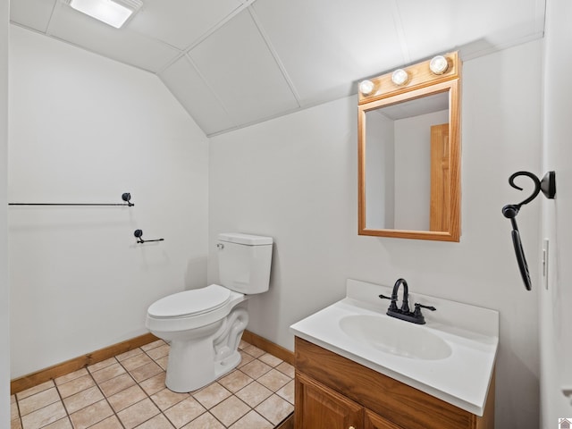 bathroom featuring vanity, toilet, tile patterned floors, and lofted ceiling