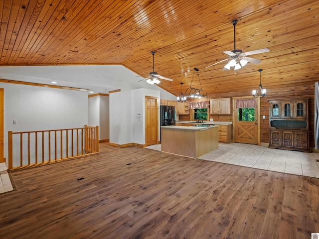 kitchen featuring ceiling fan with notable chandelier, light wood-type flooring, and wooden ceiling