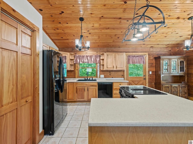 kitchen featuring black appliances, a healthy amount of sunlight, sink, and hanging light fixtures