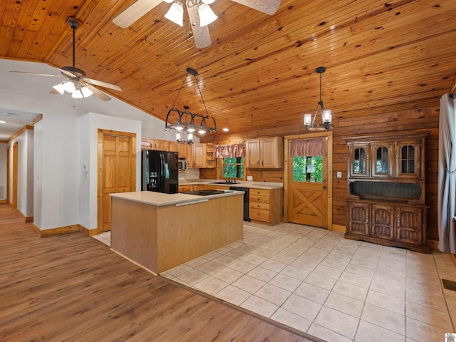 kitchen featuring a center island, light hardwood / wood-style flooring, sink, black appliances, and ceiling fan