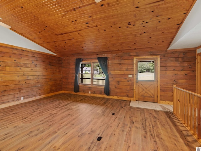 interior space featuring wooden ceiling, vaulted ceiling, plenty of natural light, and light hardwood / wood-style floors