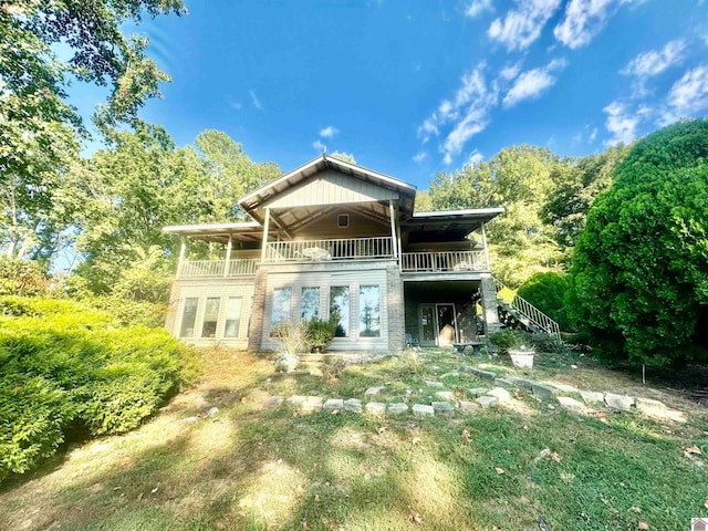 back of house featuring a balcony