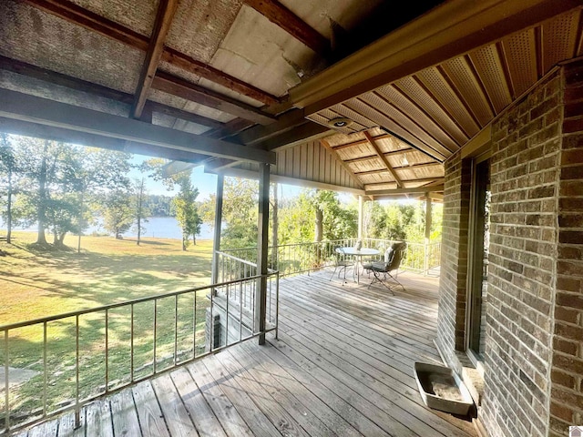 wooden terrace featuring a water view