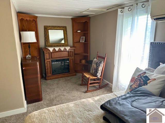 living room with light colored carpet and a wall mounted air conditioner