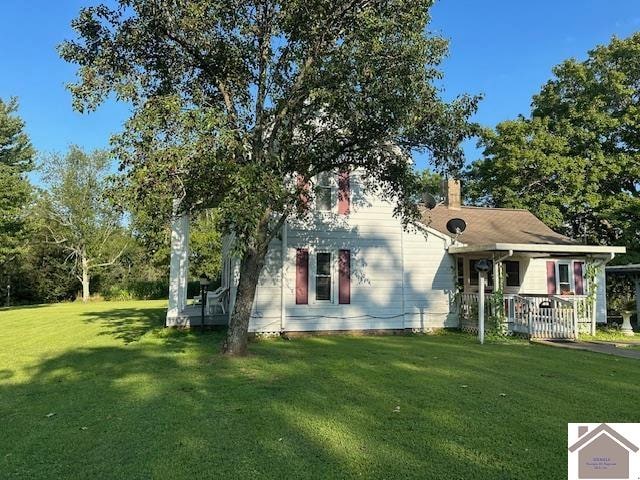 back of house with a lawn