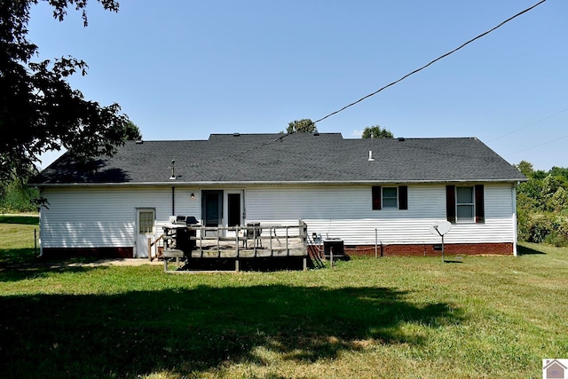 rear view of property with a lawn