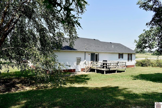 back of house with a wooden deck and a yard