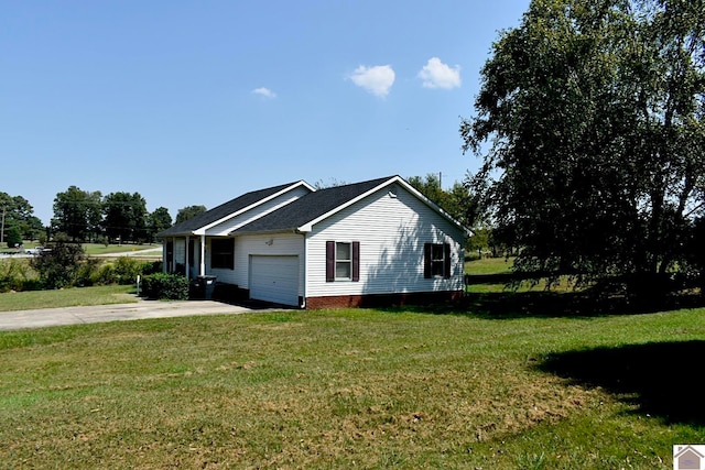 view of side of home featuring a yard and a garage