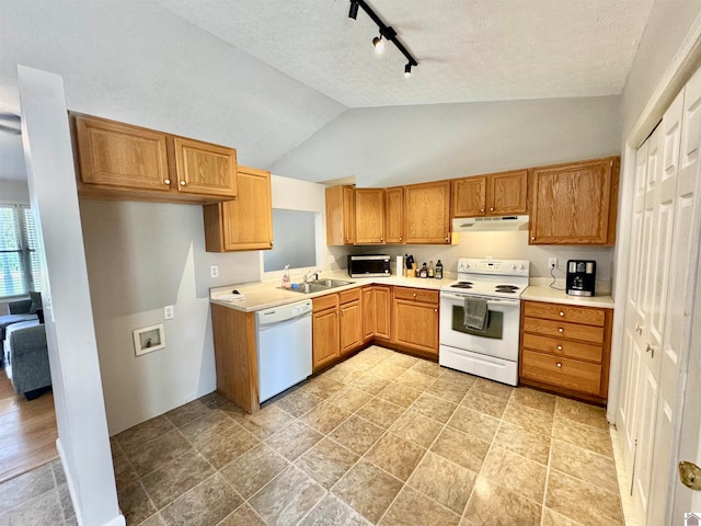 kitchen featuring a textured ceiling, white appliances, rail lighting, sink, and lofted ceiling