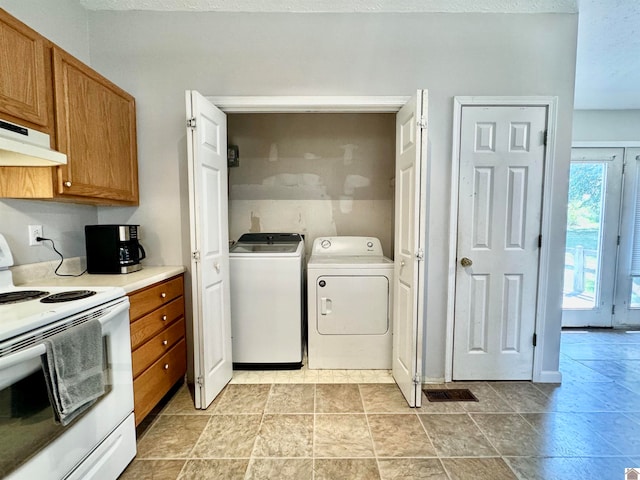 kitchen featuring white range with electric cooktop and washer and clothes dryer