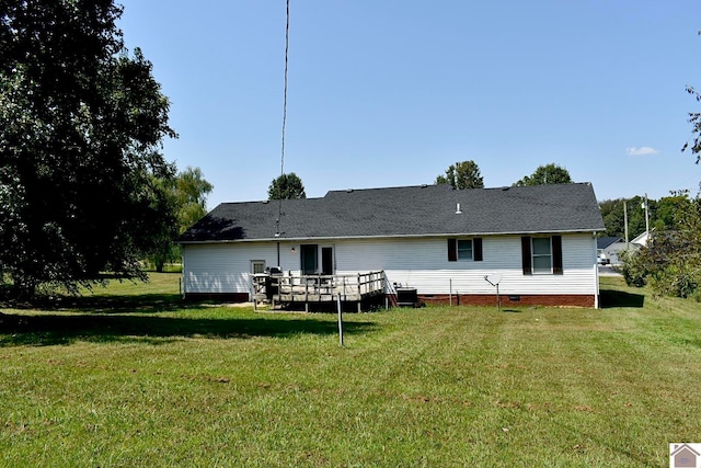 rear view of house featuring a yard