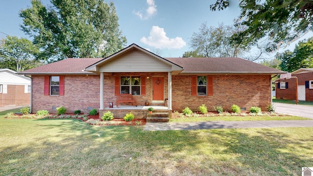 ranch-style house featuring a porch and a front yard