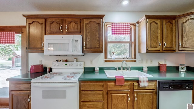 kitchen featuring white appliances and sink