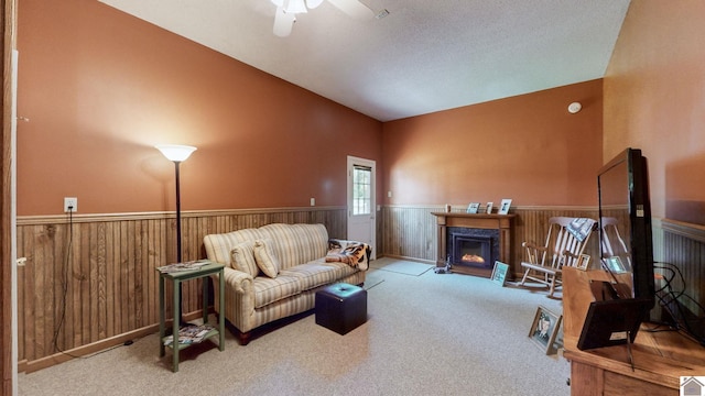 interior space with high vaulted ceiling, ceiling fan, carpet, and a textured ceiling