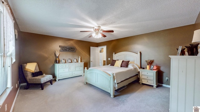 carpeted bedroom with a textured ceiling and ceiling fan