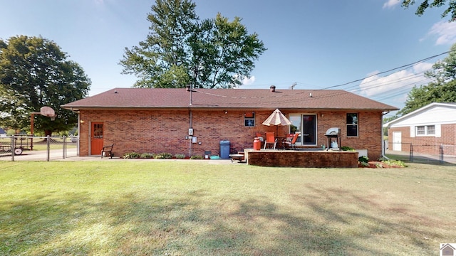 rear view of property with a yard and a patio area