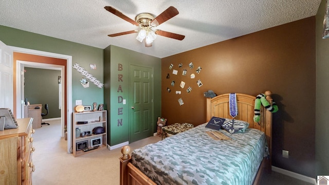 carpeted bedroom featuring a textured ceiling and ceiling fan