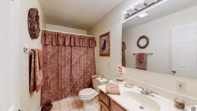 bathroom with a textured ceiling, vanity, tile patterned flooring, toilet, and a shower with curtain