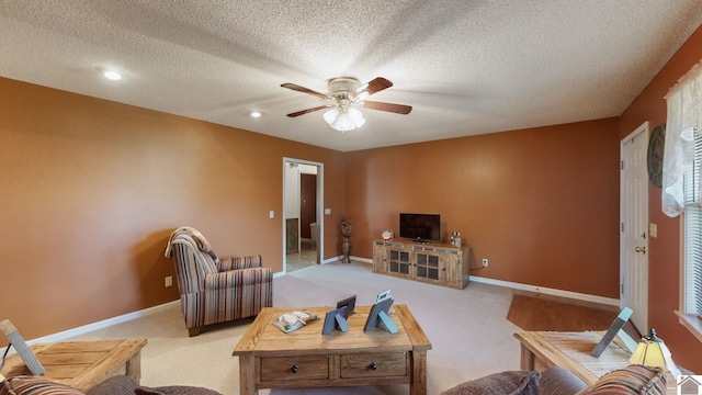 living room featuring a textured ceiling, ceiling fan, and carpet floors