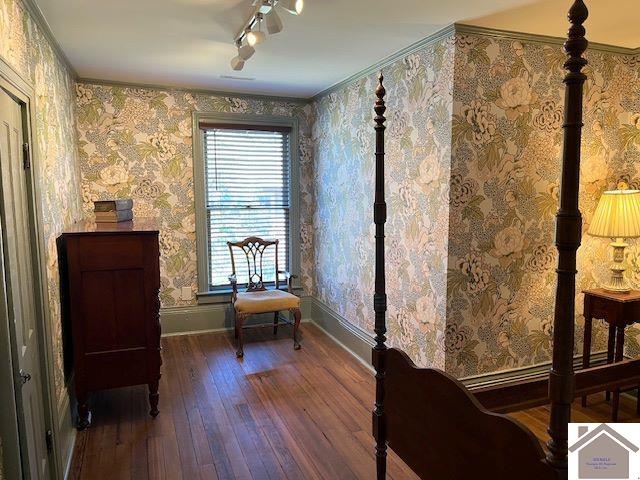 unfurnished living room featuring ceiling fan, a fireplace, dark hardwood / wood-style flooring, and ornamental molding