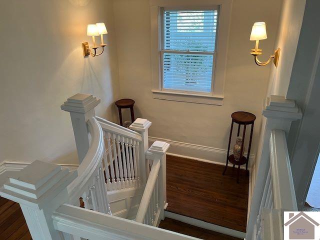 corridor with sink and light colored carpet