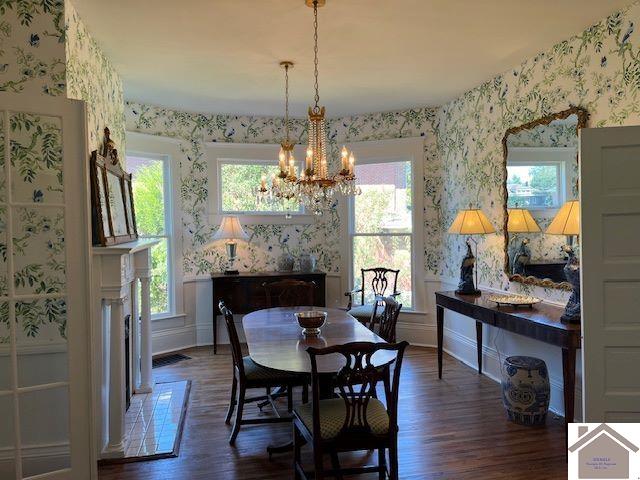 dining space with dark hardwood / wood-style floors and a chandelier