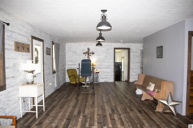 living area featuring a textured ceiling and dark wood-type flooring