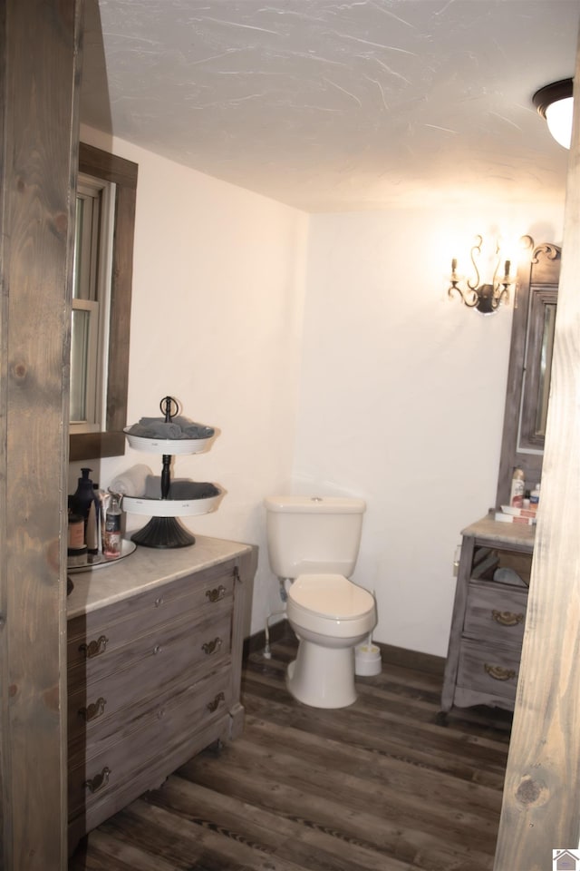 bathroom featuring vanity, toilet, and hardwood / wood-style flooring