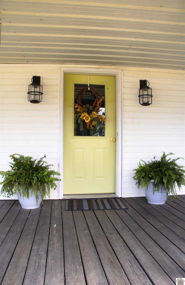 view of exterior entry featuring a wooden deck