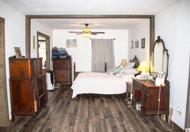 bedroom featuring ceiling fan, a textured ceiling, and dark wood-type flooring