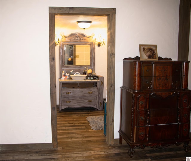 hallway with sink and dark wood-type flooring