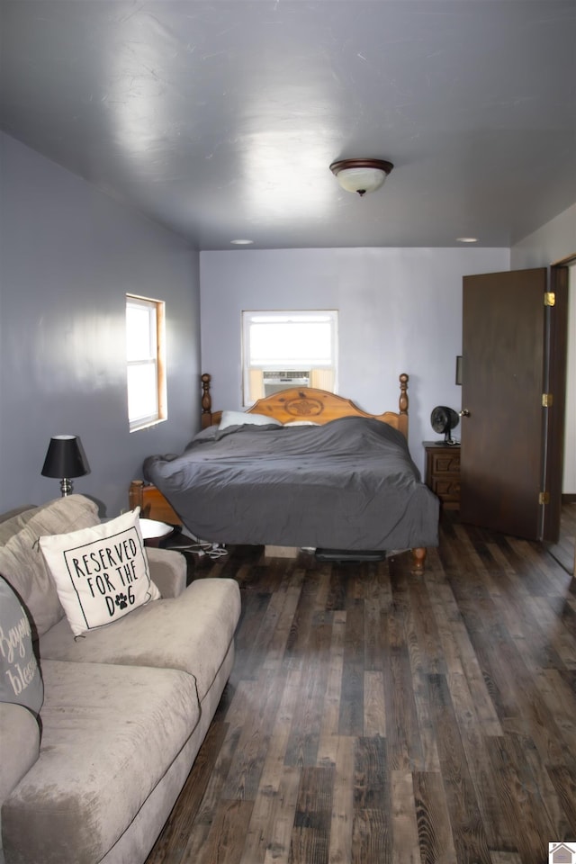 bedroom with dark wood-type flooring