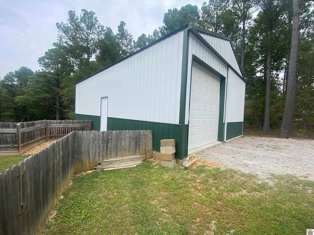 view of outbuilding with a lawn and a garage